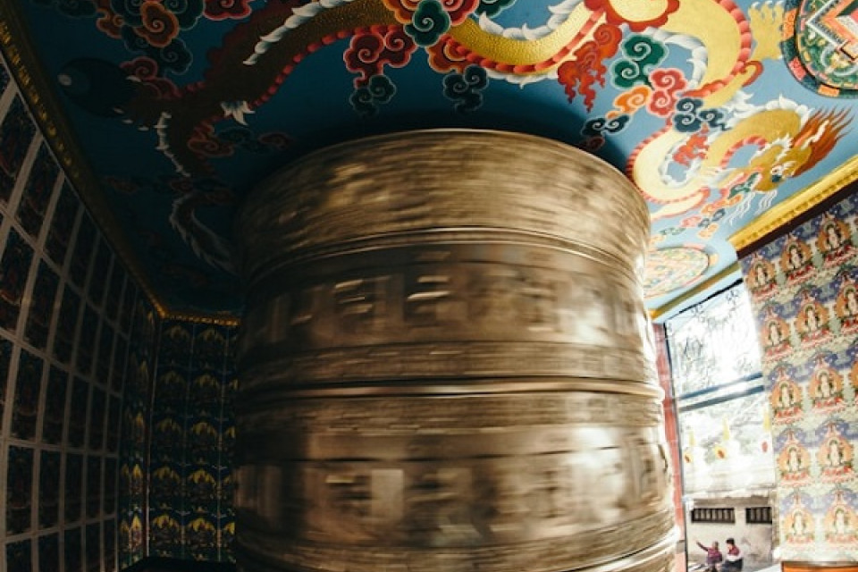 Large spinning prayer wheel with a mandala above it