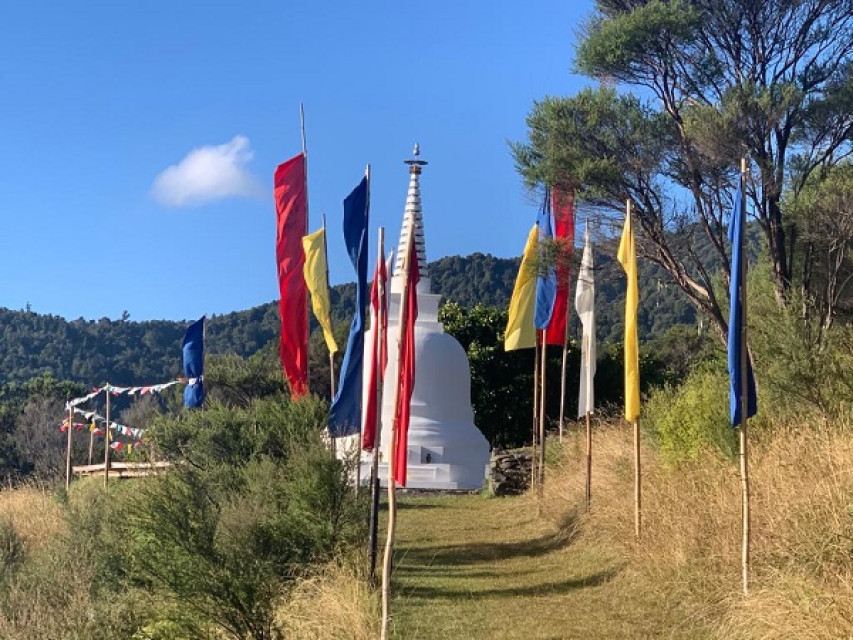 Stupa at Sudarshanaloka, with festival flags (ABC)