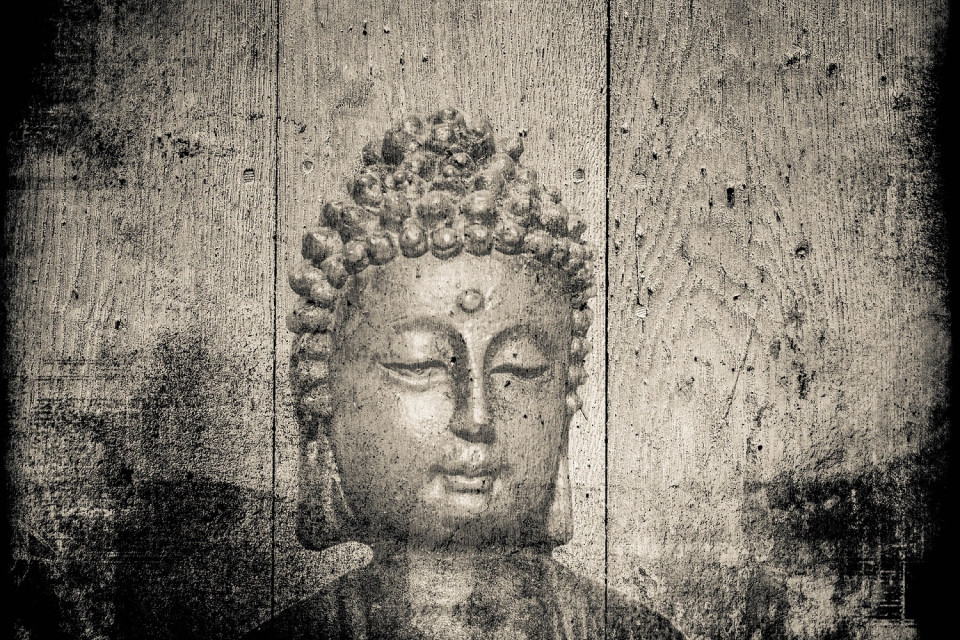 Etching of a Buddha on old wooden panels
