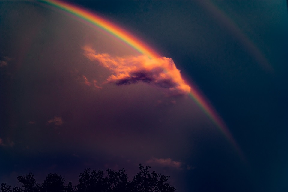Brilliant rainbow amidst a dark stormy sky